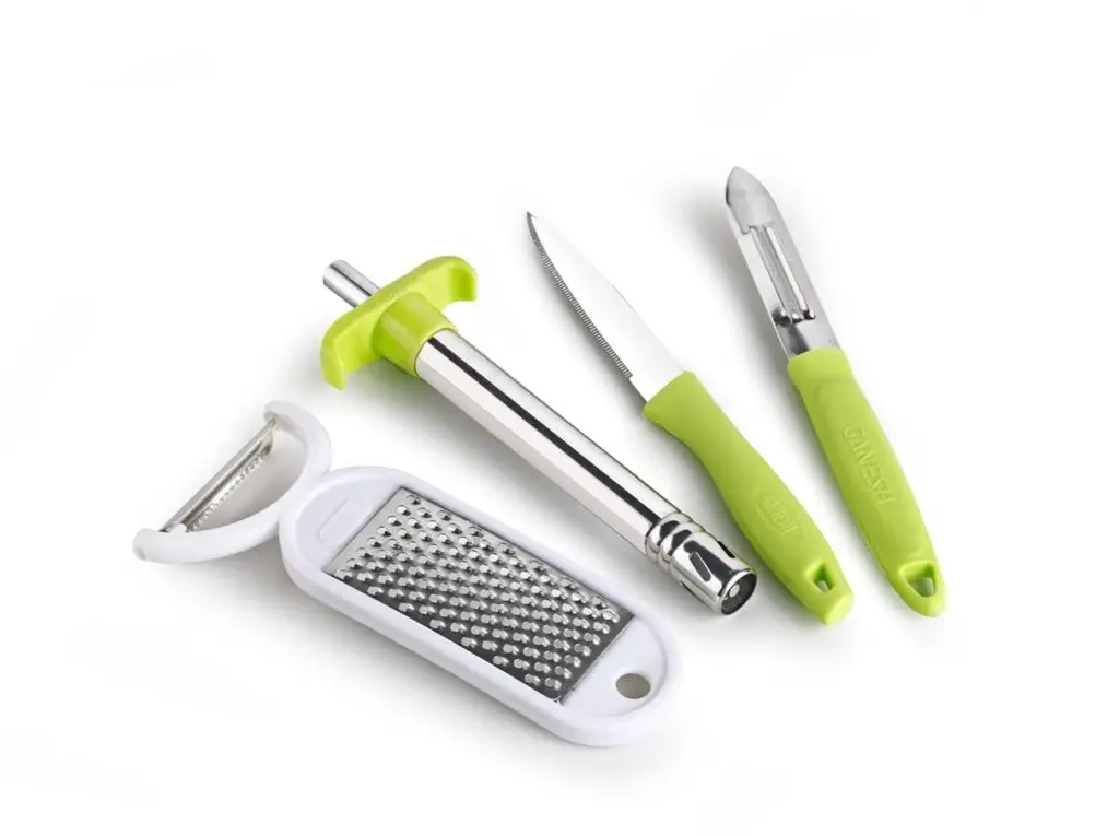 Stainless steel grater and peeler set on kitchen counter